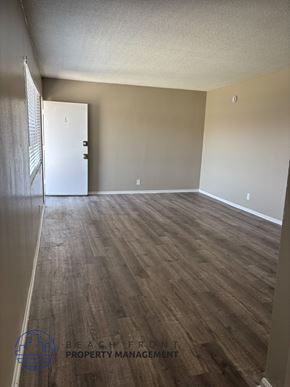 Anaheim apartment for rent - A room with wooden flooring and a white door.